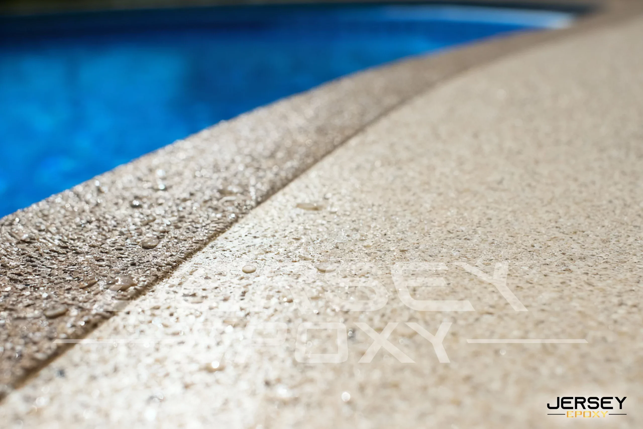 Durable epoxy coating on pool deck, slip-resistant textured surface for safety.