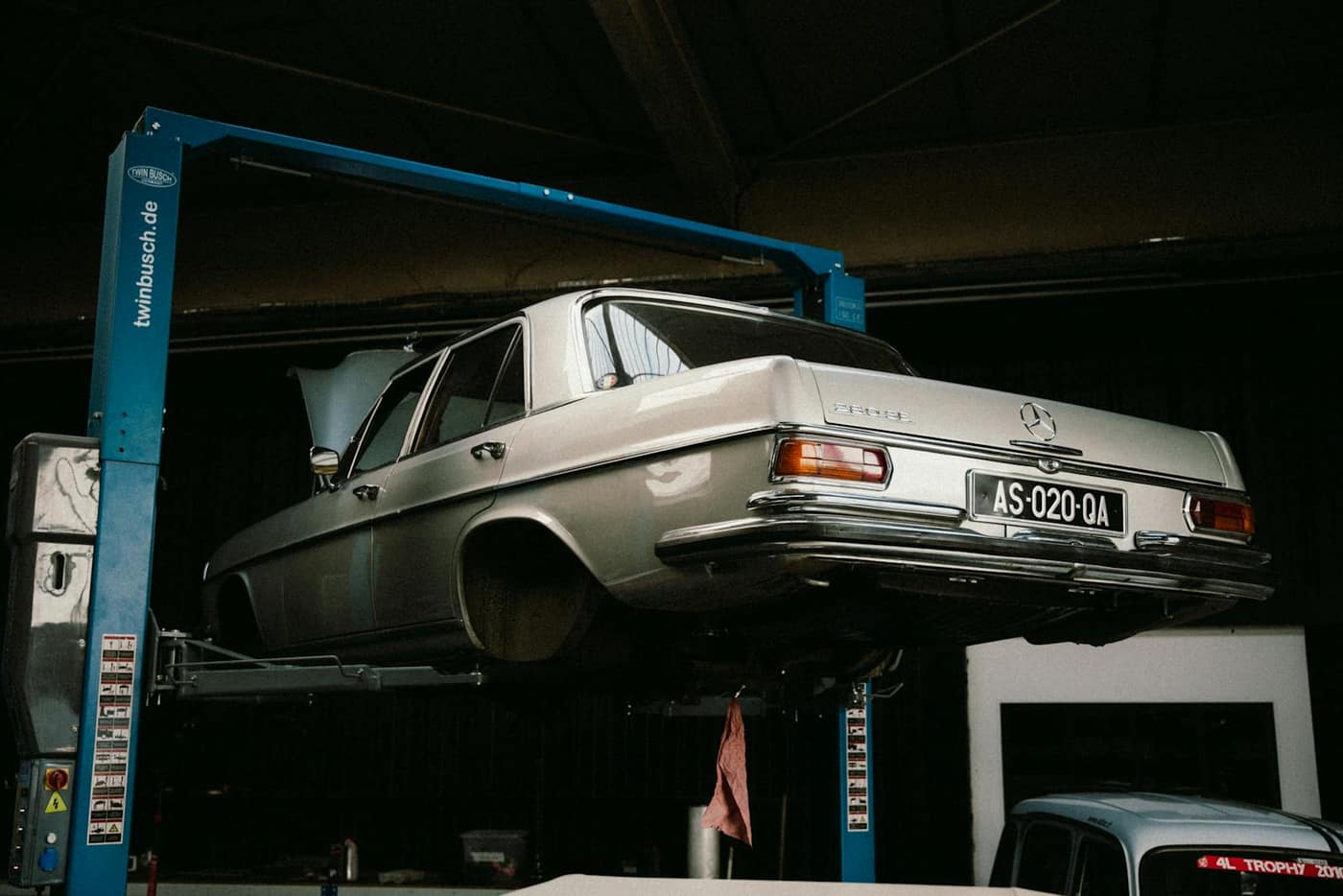 Classic car on a lift in a clean showroom-style bay