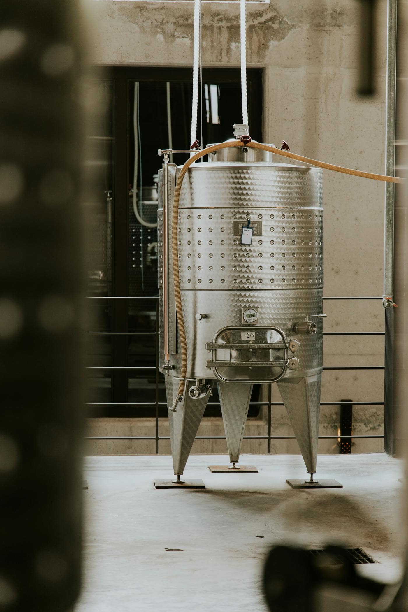 Close-up of a stainless fermentation tank in a brewery cellar