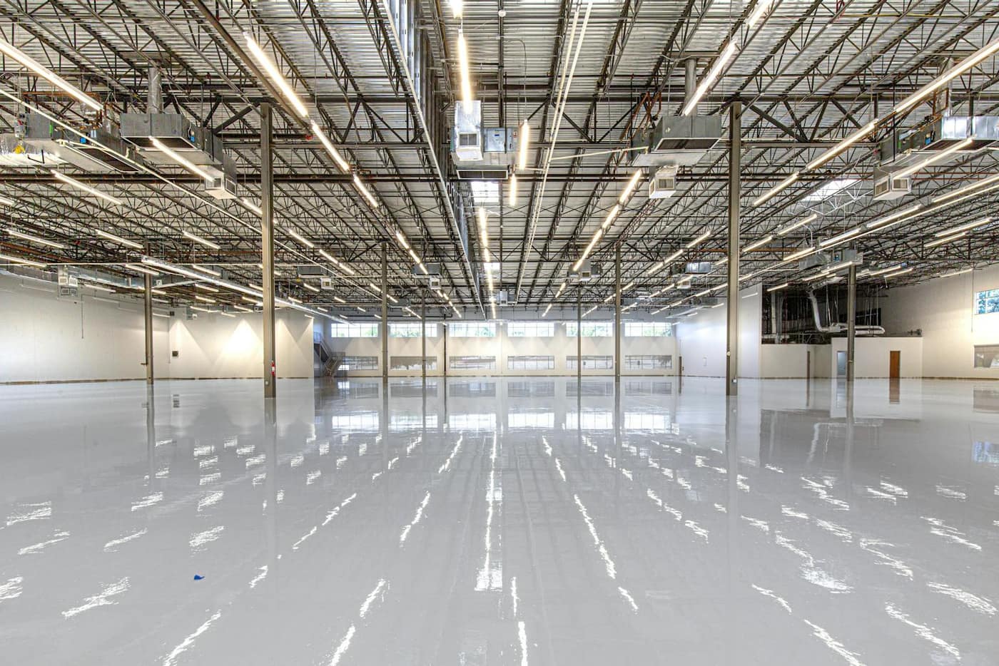 Seamless light-reflective resinous floor in an industrial space