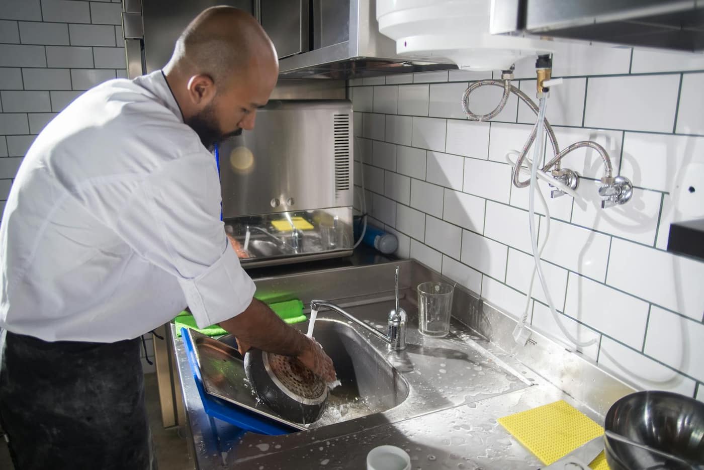 Stainless steel sink and dish-washing station in a commercial kitchen
