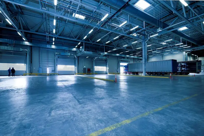 Wide sealed distribution-center floor with truck dock and pallet racking