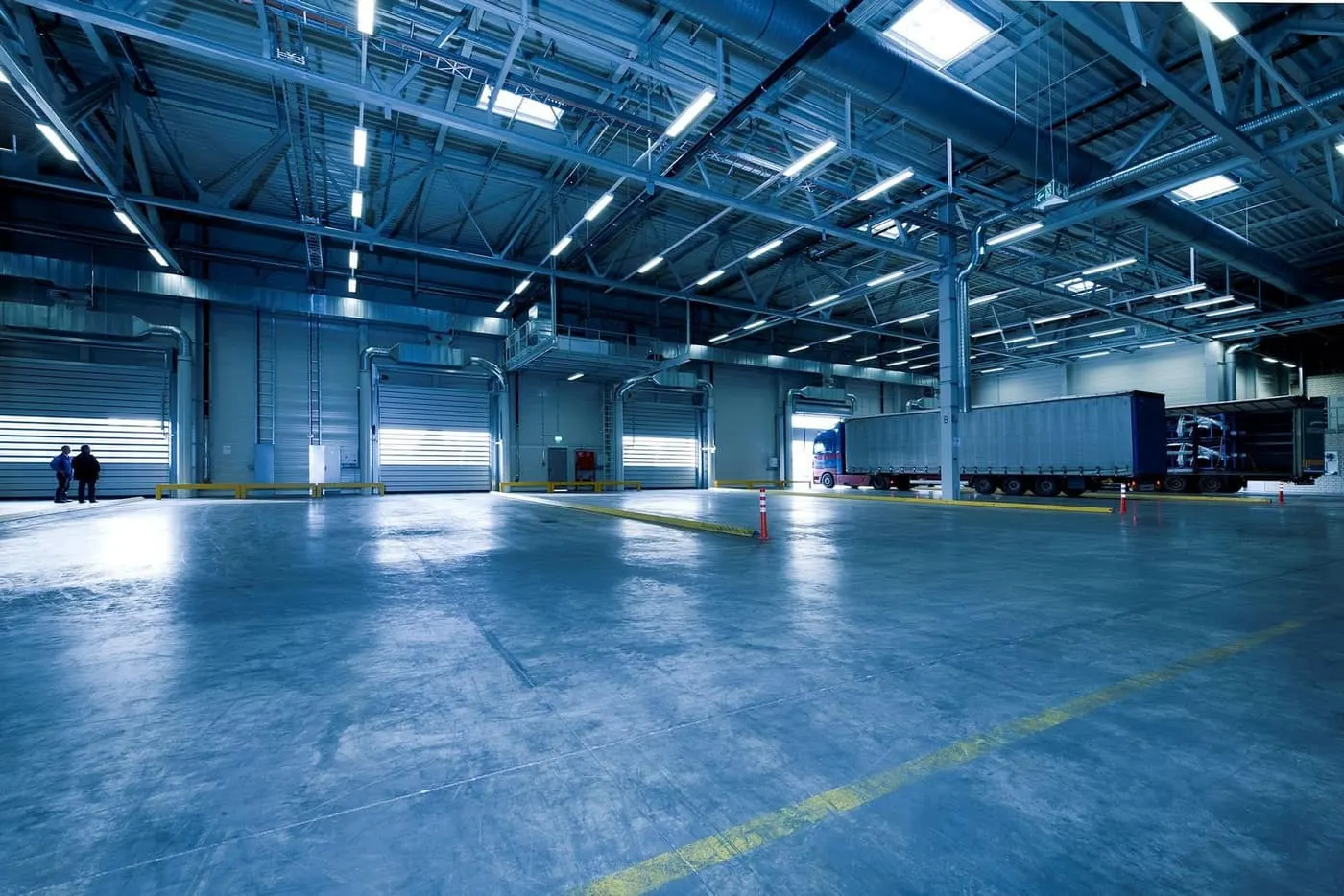 Wide sealed distribution-center floor with truck dock and pallet racking