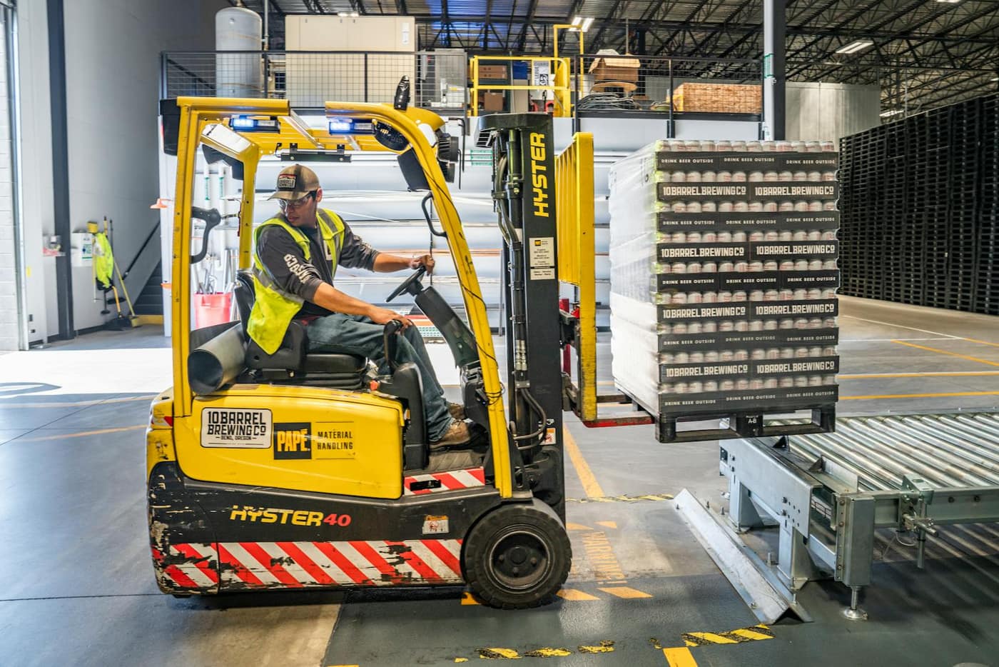 Forklift moving pallets across a sealed distribution-center floor