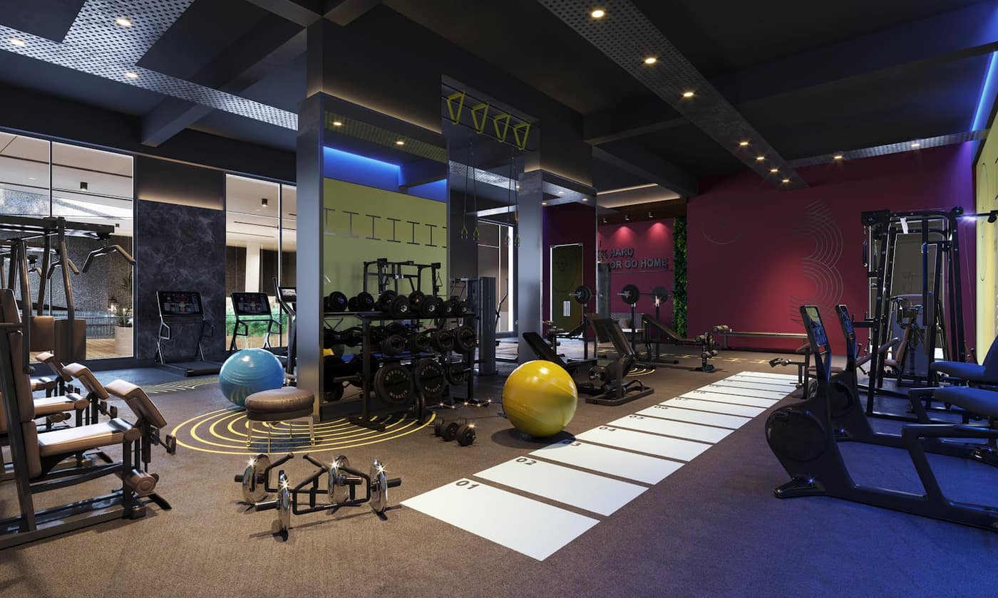 Colorful multi-zone fitness studio with branded flooring