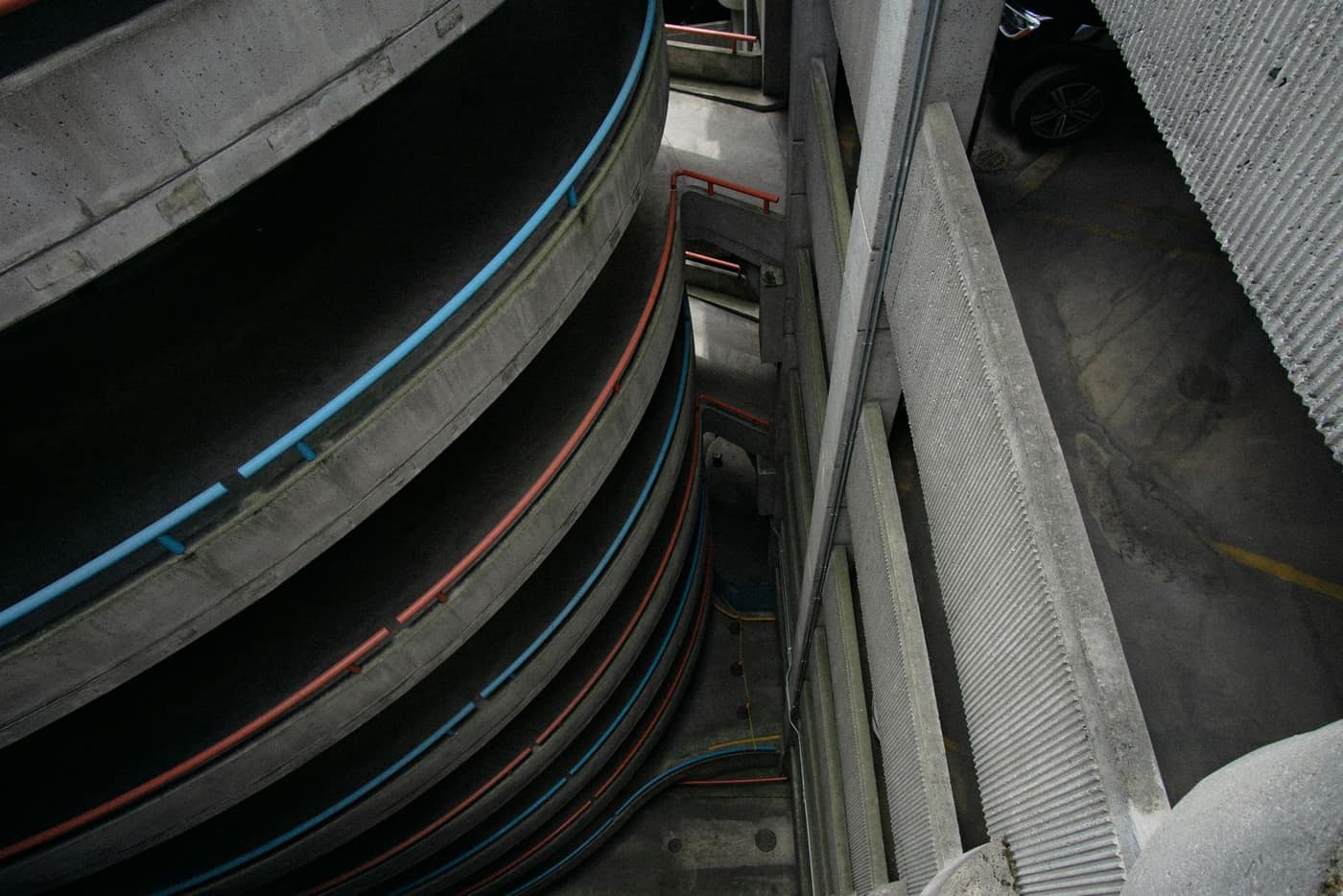 High-angle view down a helical parking-garage ramp