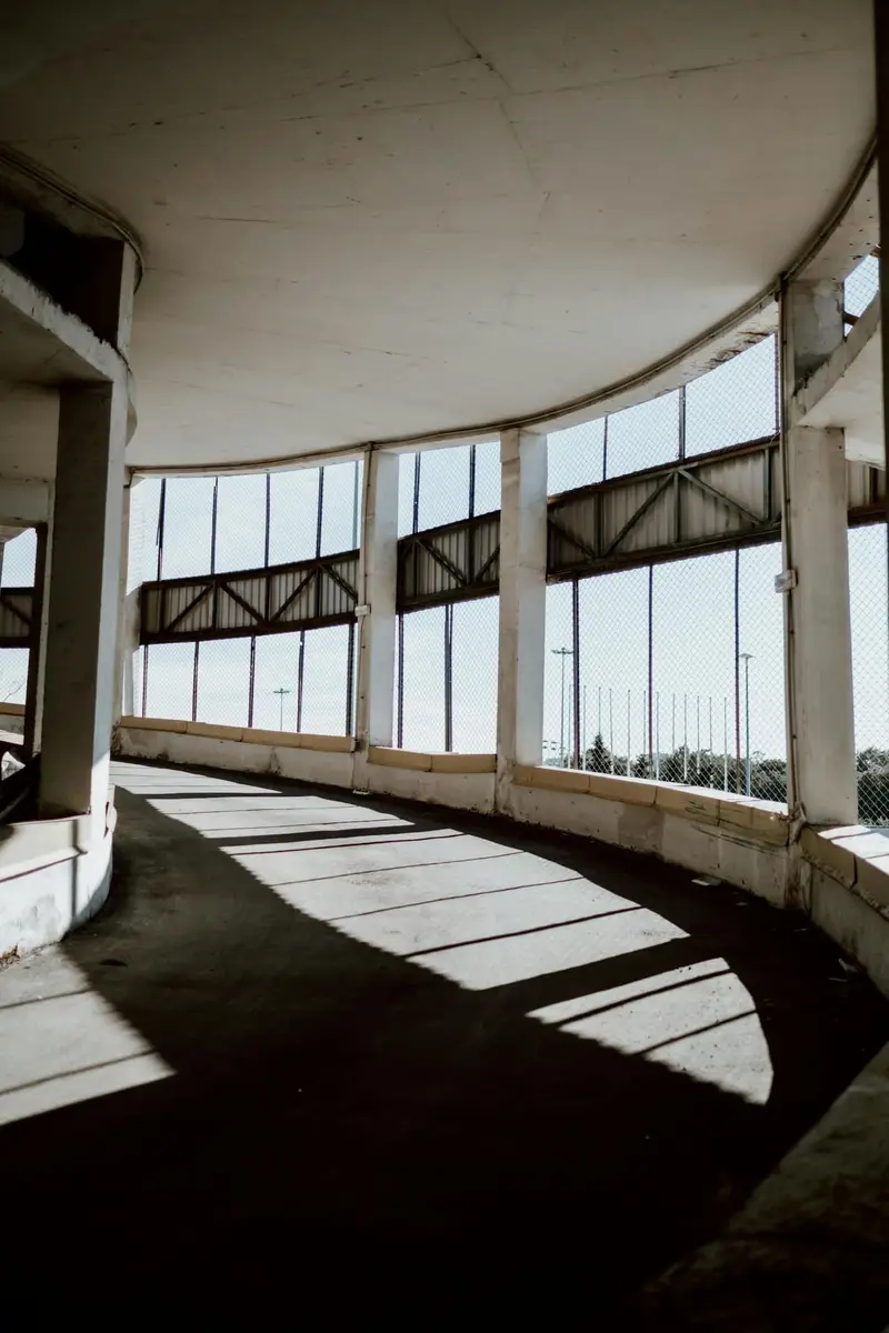 Curved concrete parking-garage ramp inside a multi-level structure