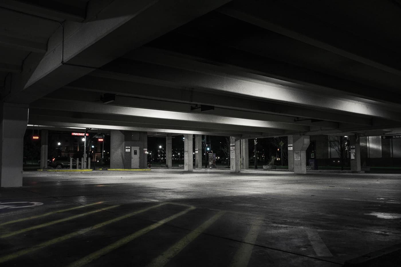 Open on-grade parking level with concrete columns
