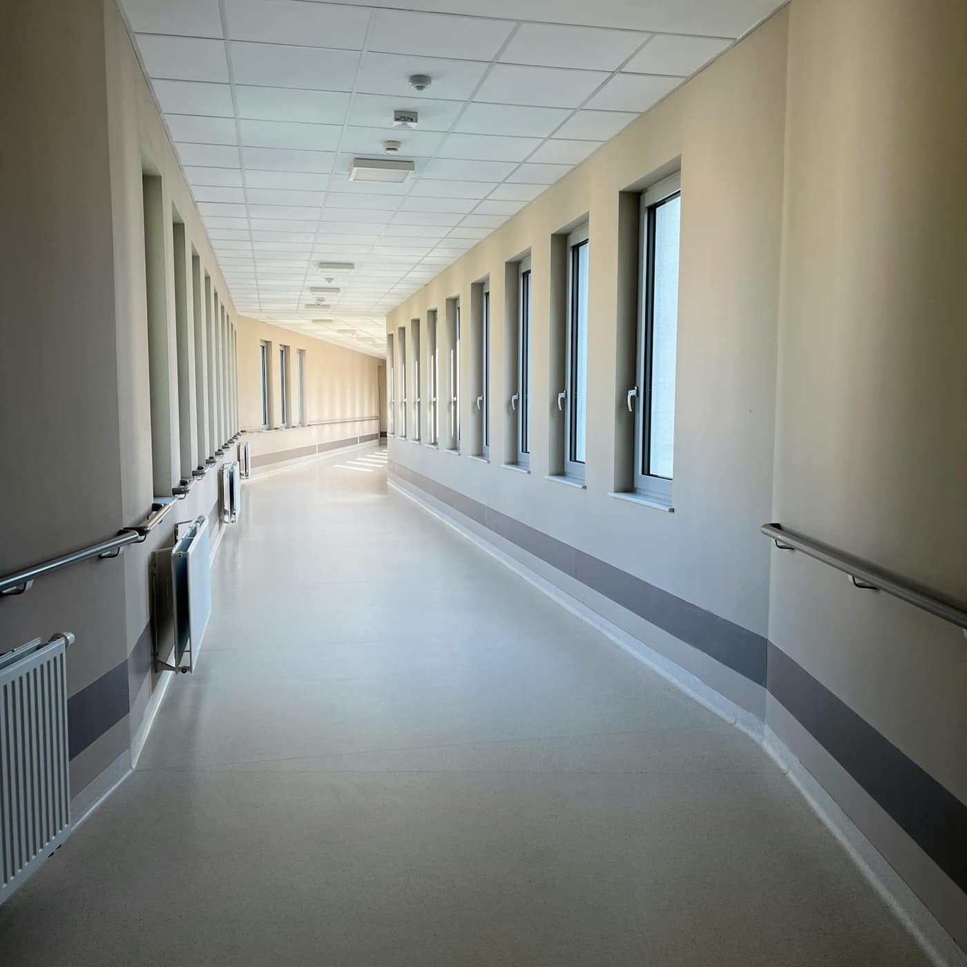 Clean, reflective decorative floor in a retail-pharmacy corridor