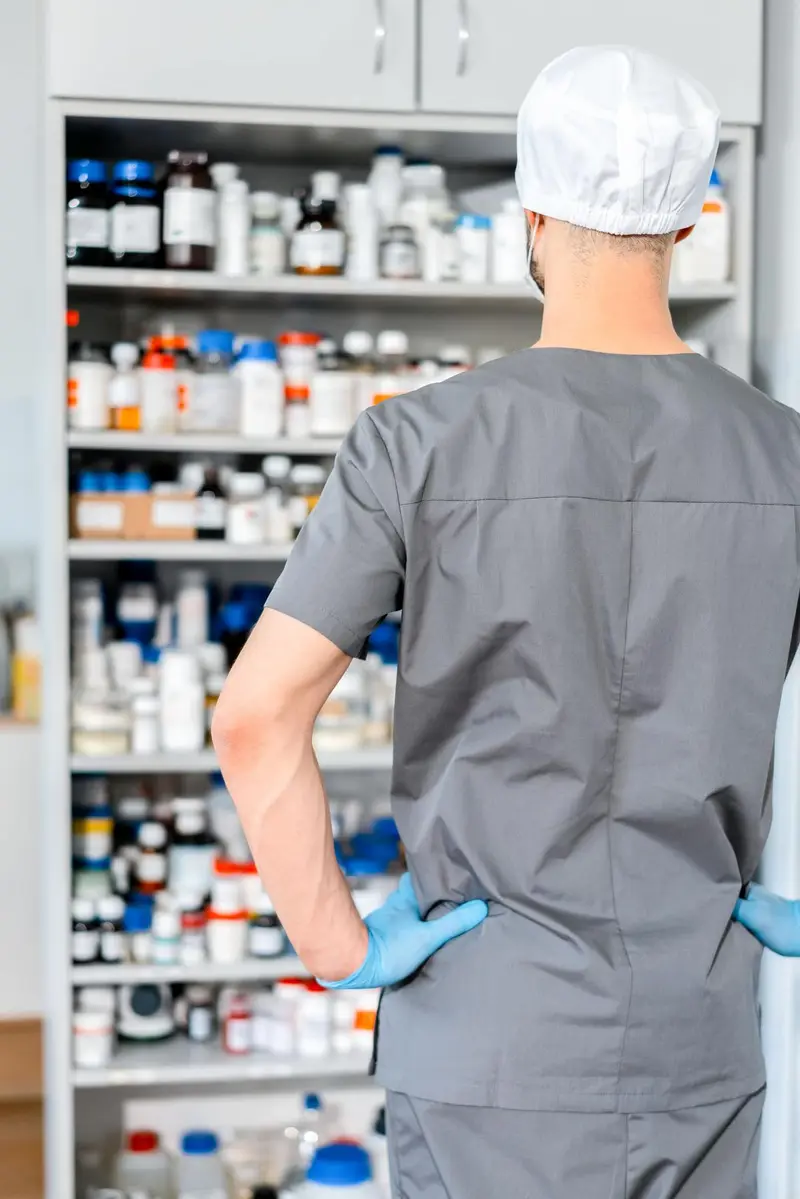 Pharmacist at a medication cabinet above a seamless, cleanable pharmacy floor