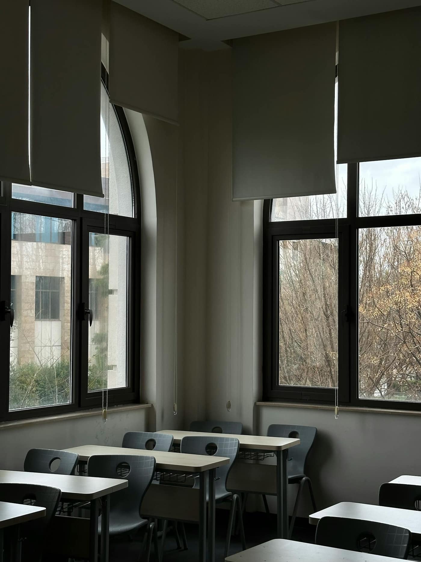 Empty classroom with worn flooring catching the afternoon light