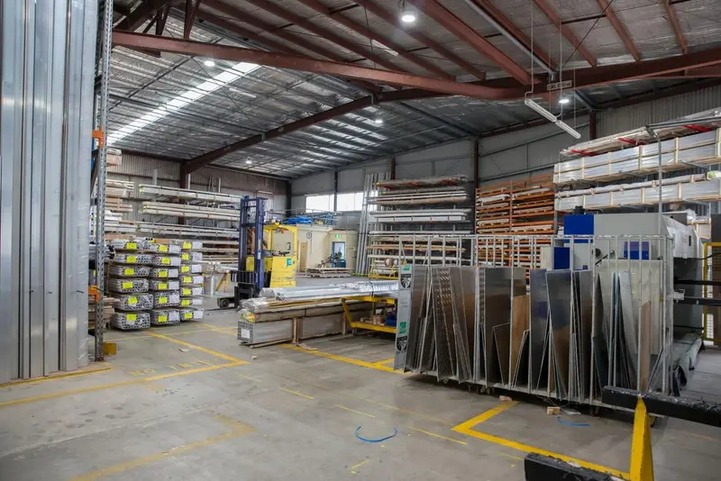 High-bay distribution warehouse with loaded pallet racking above a sealed concrete floor