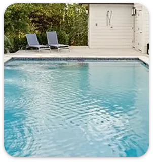 Vivid blue epoxy pool surface with clean edges and outdoor lounge area.